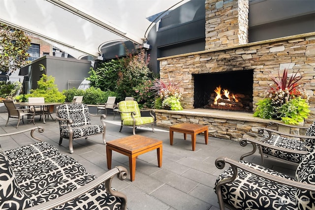 view of patio with an outdoor stone fireplace