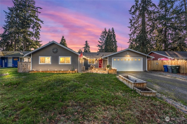 ranch-style house with a garage and a yard