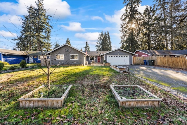 ranch-style house featuring a garage and a front yard