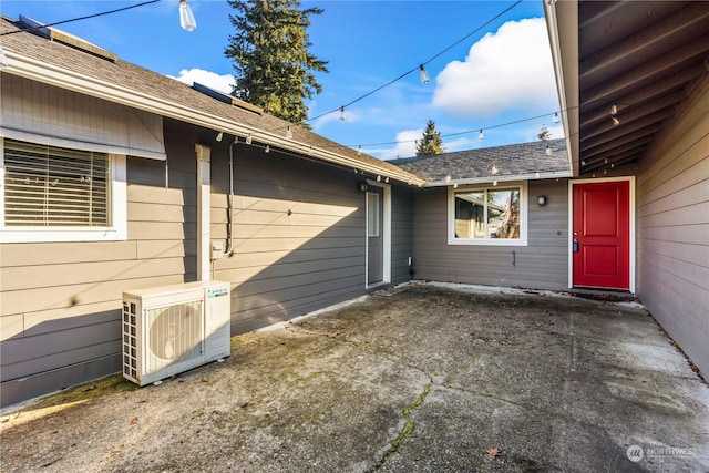 property entrance featuring a patio area and ac unit