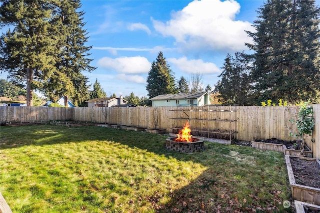 view of yard with a fire pit