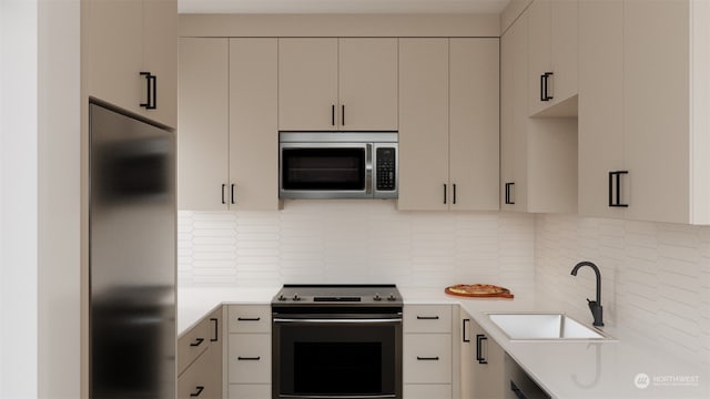 kitchen with appliances with stainless steel finishes, sink, and backsplash