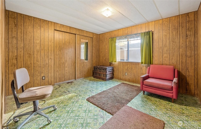 sitting room featuring wood walls