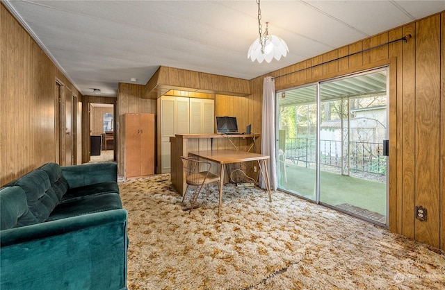 carpeted living room with wood walls