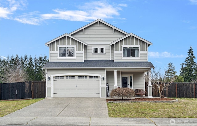 traditional-style house featuring a garage, fence, concrete driveway, board and batten siding, and a front yard