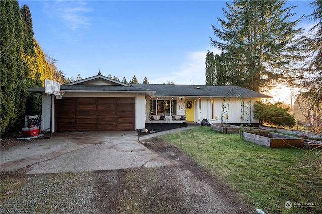 ranch-style house featuring a garage and a yard