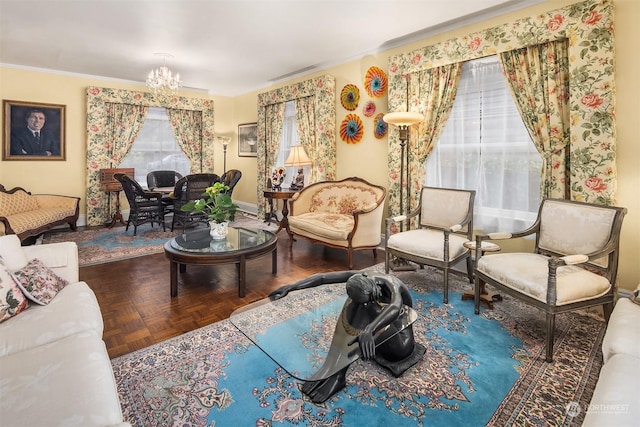 living room featuring parquet flooring, ornamental molding, and a notable chandelier