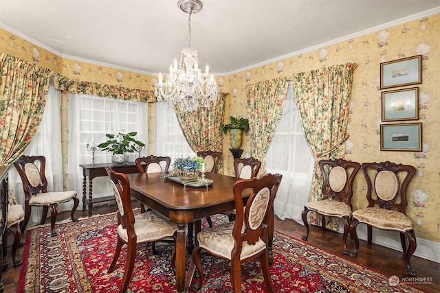 dining area with dark parquet flooring, ornamental molding, and a chandelier