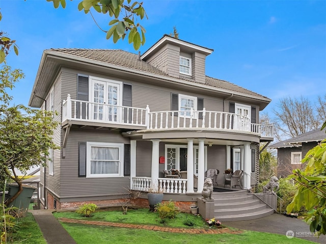 view of front of property with a balcony and covered porch