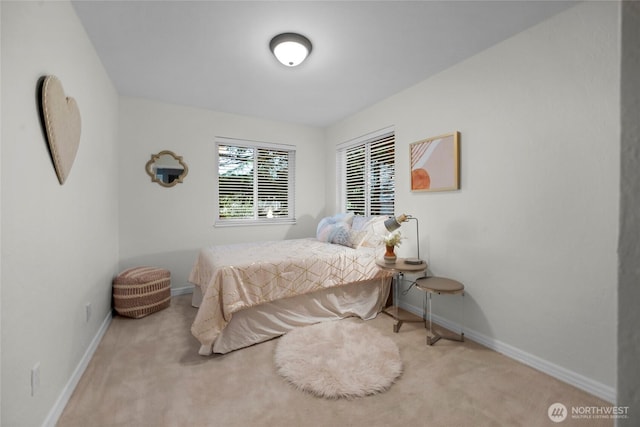 bedroom featuring baseboards and light colored carpet