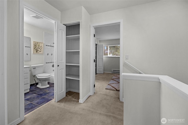 interior space featuring a baseboard heating unit and visible vents