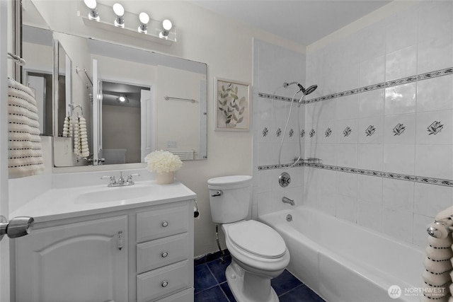 bathroom featuring toilet, tile patterned floors, bathtub / shower combination, and vanity