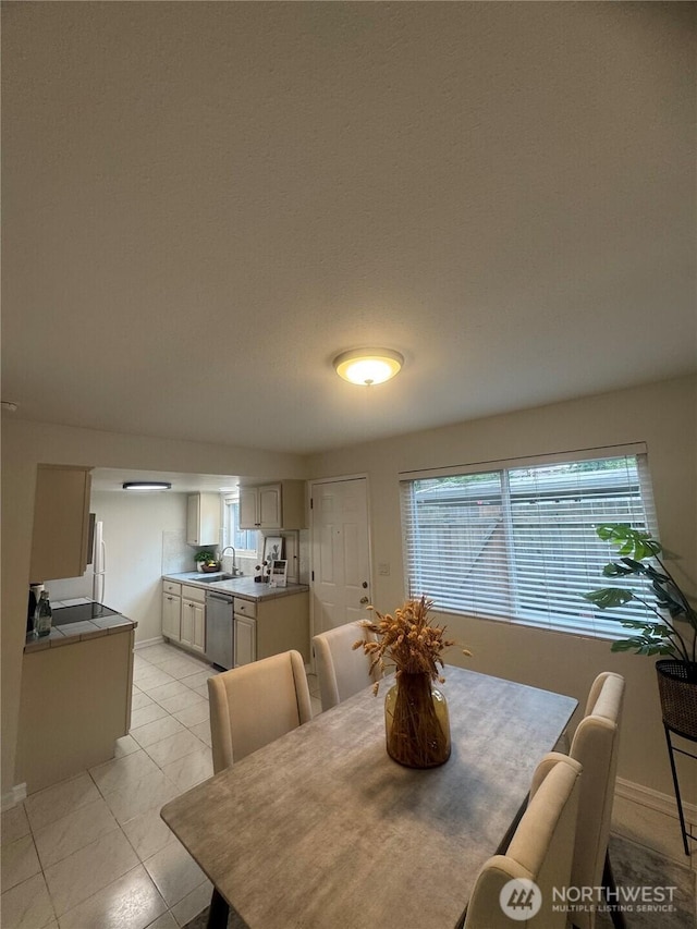 dining room with light tile patterned floors and baseboards