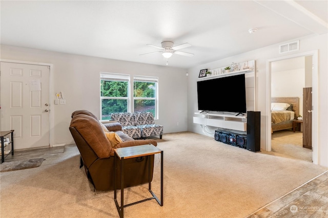 living room featuring light colored carpet and ceiling fan