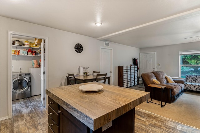 dining area with washer / clothes dryer and dark hardwood / wood-style flooring