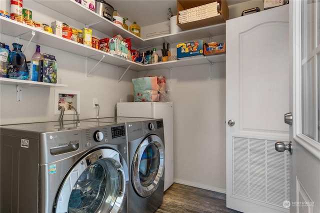 clothes washing area featuring dark wood-type flooring and washer and dryer