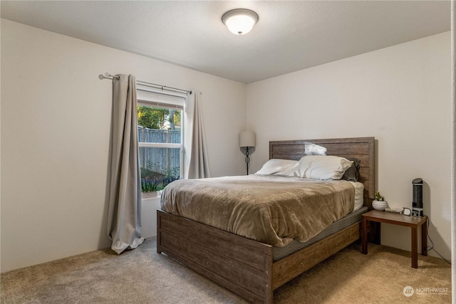 bedroom featuring light colored carpet