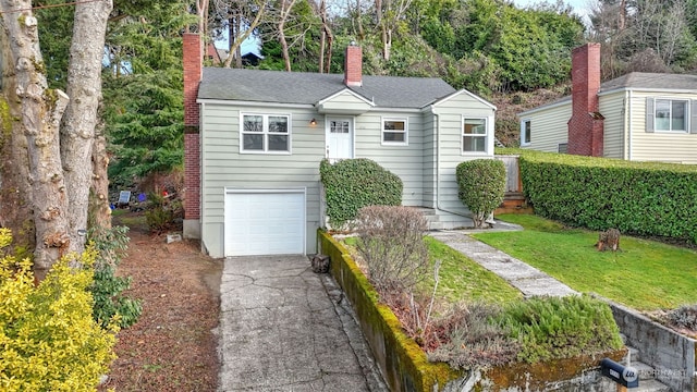 view of front of house with a garage and a front lawn