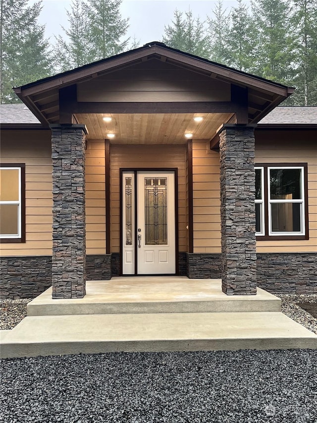 view of exterior entry with a porch