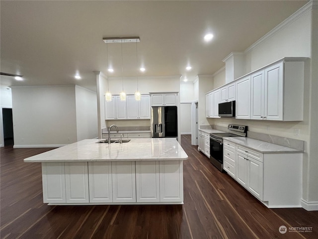 kitchen featuring appliances with stainless steel finishes, decorative light fixtures, sink, a kitchen island with sink, and light stone counters