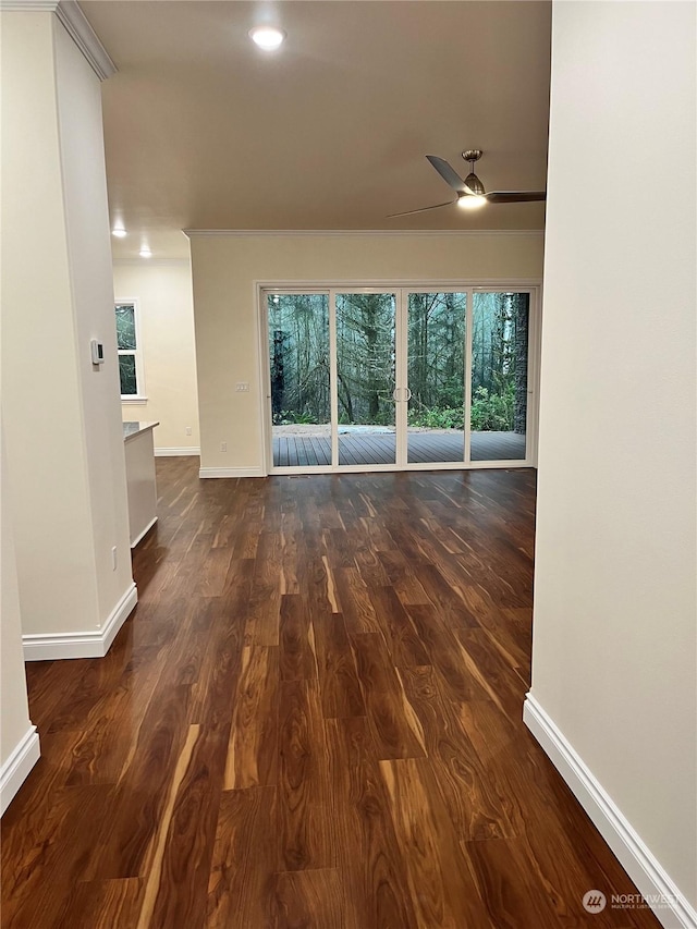 unfurnished living room featuring ceiling fan and dark hardwood / wood-style floors