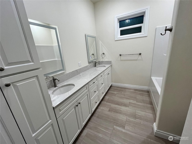 bathroom featuring vanity and a washtub