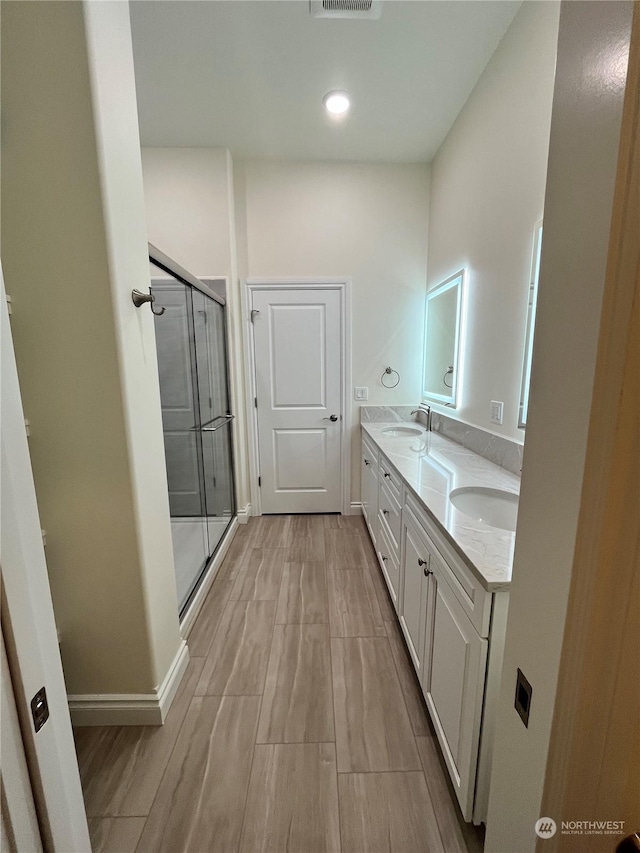 bathroom with vanity and an enclosed shower