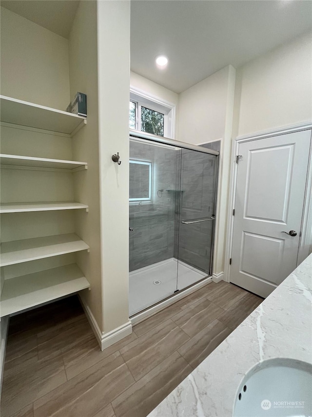 bathroom with vanity and a shower with shower door