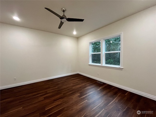 unfurnished room with dark hardwood / wood-style floors and ceiling fan