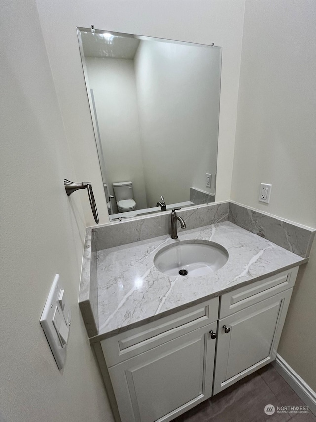 bathroom with vanity and toilet