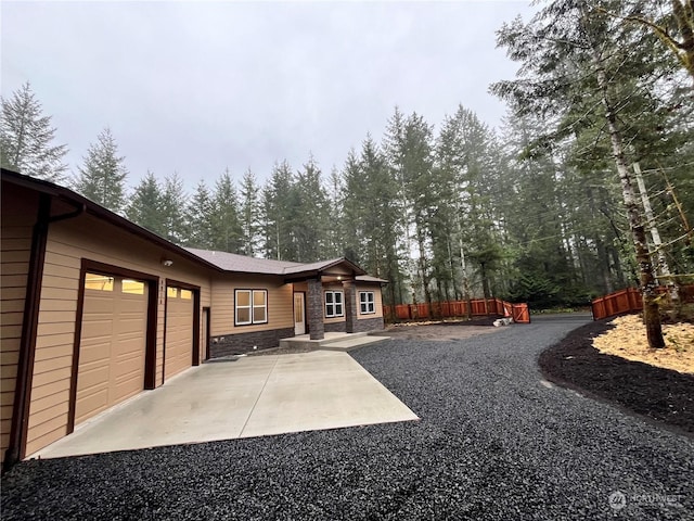 back of house featuring a garage and a patio