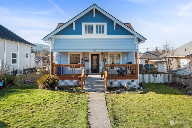 bungalow featuring a porch and a front lawn