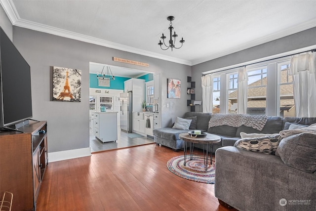 living room featuring an inviting chandelier, ornamental molding, dark hardwood / wood-style floors, and a textured ceiling