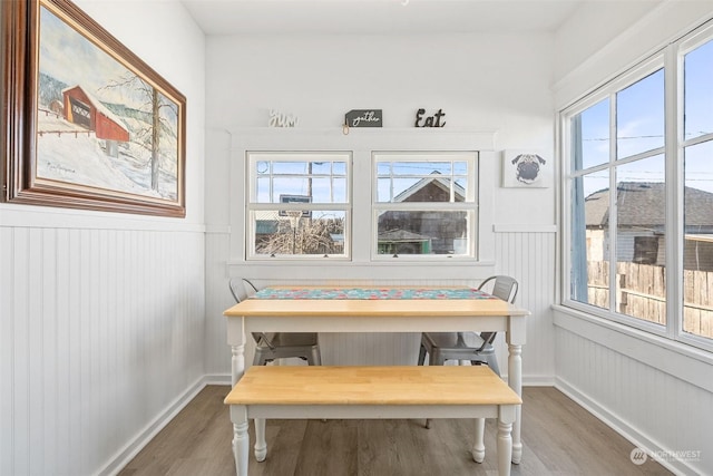 dining room featuring a healthy amount of sunlight, hardwood / wood-style floors, and breakfast area