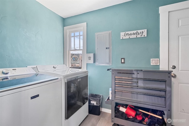 washroom featuring light hardwood / wood-style flooring, electric panel, and independent washer and dryer