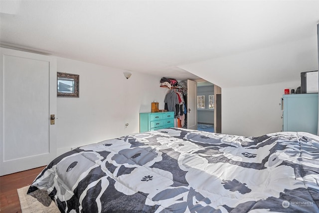 bedroom with dark wood-type flooring