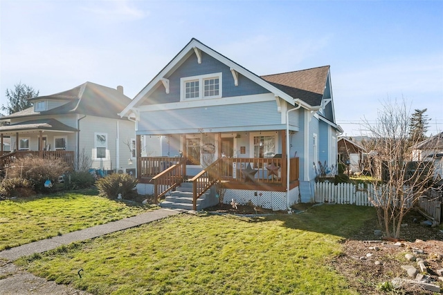 view of front of property with a front yard and covered porch