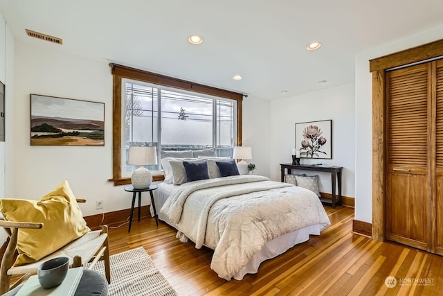 bedroom with hardwood / wood-style flooring and a closet