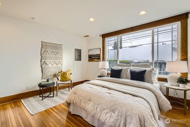 bedroom with wood-type flooring and electric panel