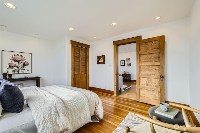 bedroom featuring light wood-type flooring and a closet