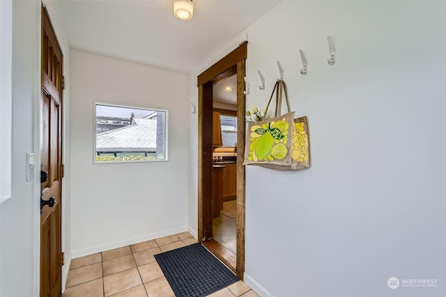 doorway to outside featuring light tile patterned flooring