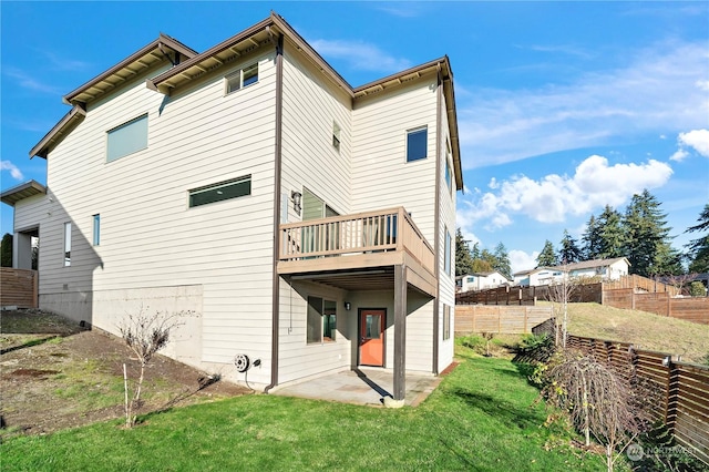 back of property featuring a patio and a yard