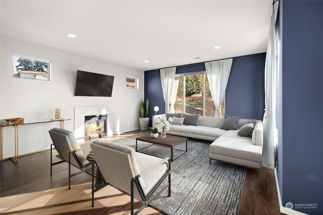 living room with wood-type flooring and a fireplace