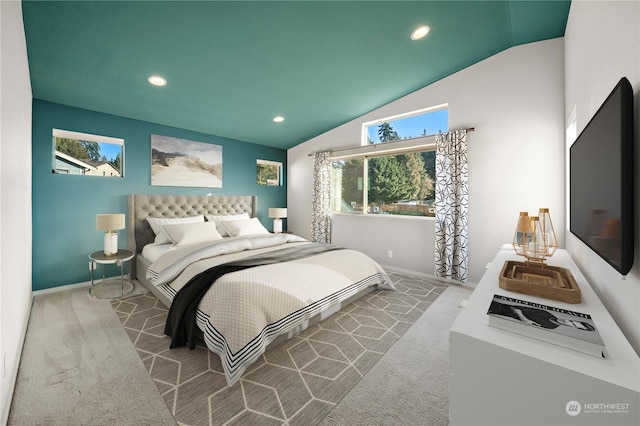 bedroom with vaulted ceiling and light colored carpet