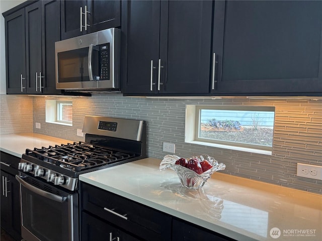 kitchen featuring stainless steel appliances and decorative backsplash