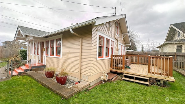 view of home's exterior featuring a yard and a deck