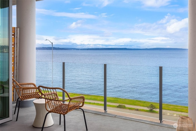 balcony featuring a water and mountain view