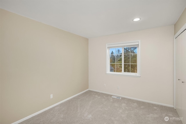 unfurnished bedroom featuring baseboards, visible vents, light colored carpet, a closet, and recessed lighting