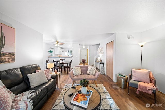 living room featuring ceiling fan and wood-type flooring