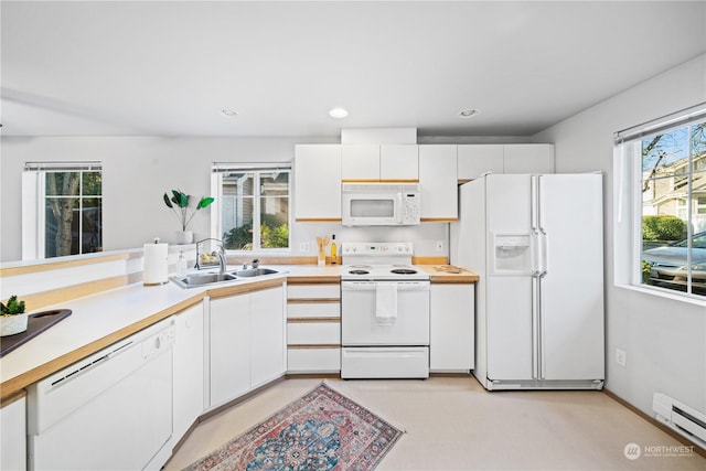 kitchen featuring sink, white cabinets, white appliances, and baseboard heating